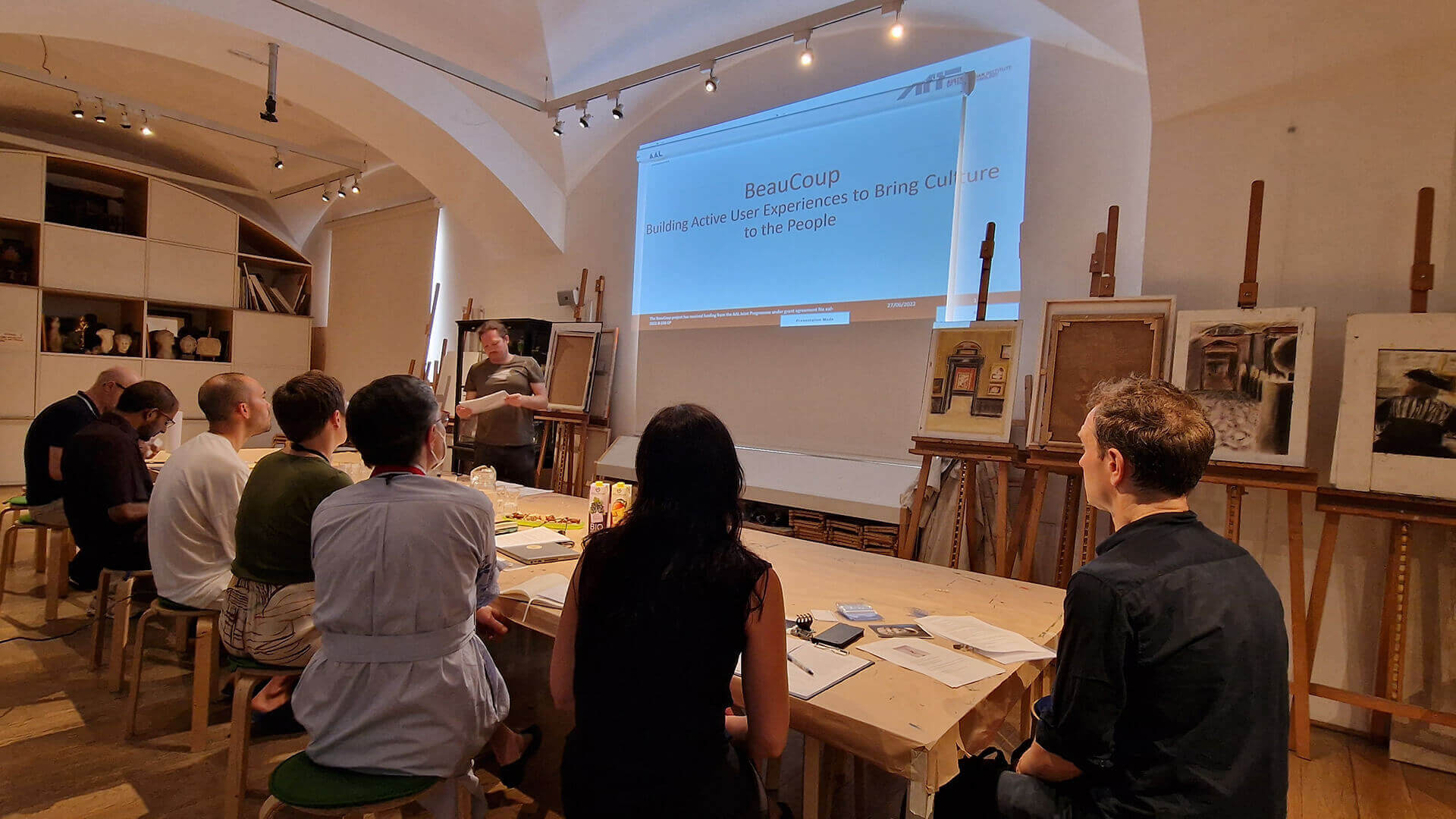 museum staff watching presentation