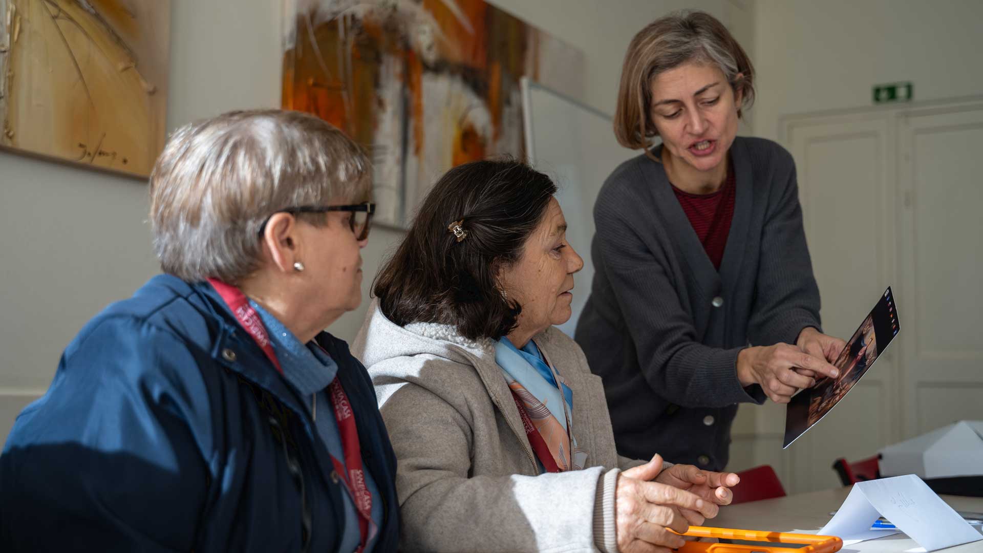 two eldery women learning to handle Beacoup Products.